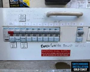 A close-up of another electrical switchboard installed on a wall, showing the wiring and switch configuration.